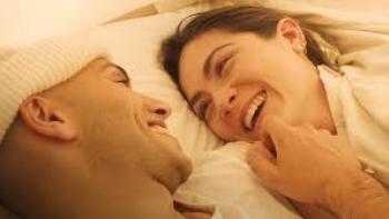 Wish You Were Here movie photo: Mena Massoud laughs with Isabelle Fuhrman in a bed