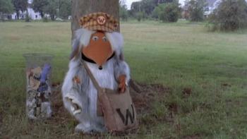 Wombling Free: A Womble in a park next to a litter bin