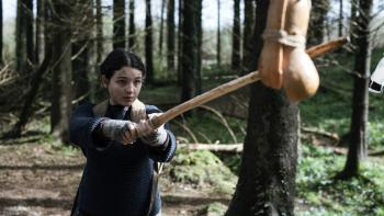Worldbreaker movie: Billie Boullet uses a stick to smash a sack hanging from a tree in the woods