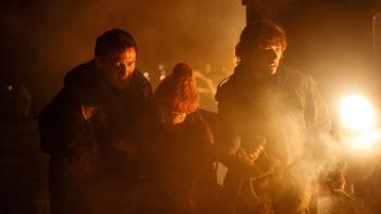 Worldbreaker movie: Milla Jovovich, Luke Evans, and Billie Boullet walk through a battle area