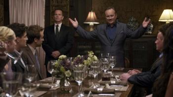 Would You Rather: Dining room scene with a man standing and speaking to seated guests