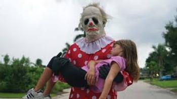 Wrinkles the Clown Movie: Sad-looking clown holds young girl