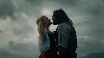 Wuthering Heights movie: Cathy (Margot Robbie) and Heathcliff (Jacob Elordi) are face to face against the stormy moor sky