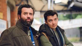 Your Christmas or Mine?: A bearded White man sits on a bench with a younger White man.