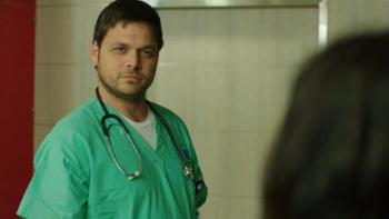 Yossi: Ohad Knoller wears hospital scrubs with a stethoscope around his neck