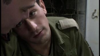 Yossi & Jagger: One male Israeli soldier leans toward another and looks at him longingly