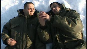 Yossi & Jagger: Two Israeli soldiers lay together in the snow looking at a portable radio