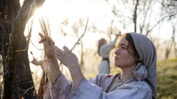 You Won't Be Alone: Alice Englert holds pieces of hay up to the sunlight
