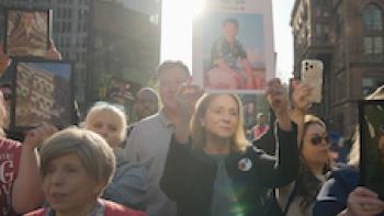 Your Attention Please: Moms protest with pictures of their children.