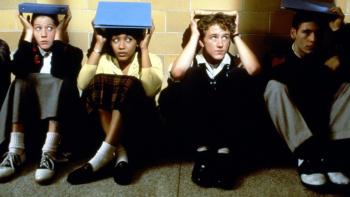 Liberty Heights: School students put their books on their heads while sitting on the floor