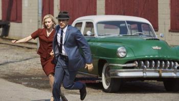 11.22.63 TV show: A man and woman are running from a 1960s green car.
