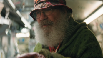 4x20: Quick Hits TV show screenshot 3: a glass artist affected by Operation Pipe Dream; he has a long gray beard and a hat