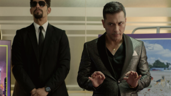 90 Minutes TV show screenshot 2: A body guard stands by Yuriel Santana during a presentation. 