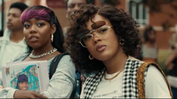 A Different World TV show screenshot 3: Maleah Joi Moon and Alijah Kai. Moon wears flip-up sunglasses. Kai carries a binder with her face on it.