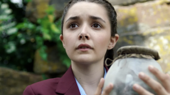 A Kind of Spark screenshot 1: Adie holds an old strange glass lamp.