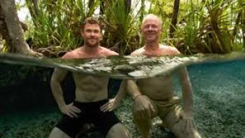 A Road Trip to Remember TV show screenshot #3: Father and son Hemsworths stand smiling together in water
