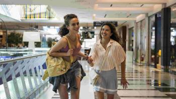 Adoration TV show screenshot 1: Alice Lupparelli grabs Noemi Magagnini’s hand and runs through the halls of a mall.