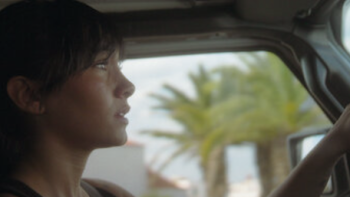 Aitana: Metamorphosis screenshot 2: Aitan driving a car with baseball cap.