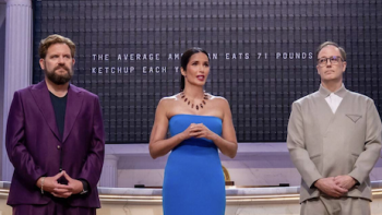 America's Culinary Cup TV show screenshot 1: Michael Cimarusti wearing purple stands next to Padma Lakshmi in blue dress, Wylie Dufresne in gray suit.