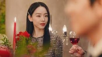 The Art of Sarah TV show screenshot: Sarah sits at a dining table, with candles in front of her.