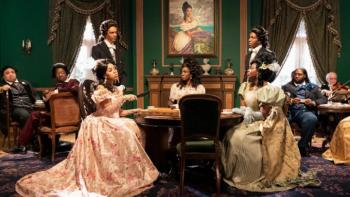 Astronomy Club TV Series: A group of people in elaborate vintage costumes sit in a Versailles-like room. 