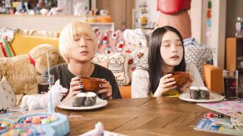 Baby Assassins Everyday!: Mahiro (Left) and Chisato (Right) eat at a coffee table in a brightly lit room, their eyes closed as they savor the soup.