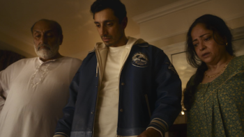 Bait TV show screenshot 2: Shah Latif stands with his parents looking down. 