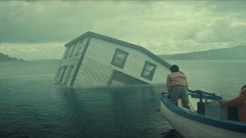 Below TV show screenshot: People in a rowboat watch as a house sinks in the water