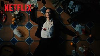 Berlin and the Lady with an Ermine: Man in a suit with a bullet hole in his chest lying on tile floor, surrounded by scattered items.