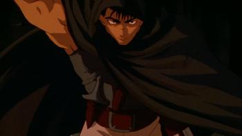 Berserk TV show: Guts has his hand on his massive sword ready to unsheathe it from underneath a large dark cloak he's wearing