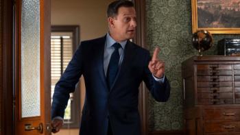 Best Medicine TV show screenshot 1: Dr. Martin pauses in a hallway, dressed in a black suit. He looks confused.