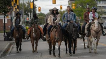 Beyond Black Beauty TV: Smiling Black family riding horses in the streets of Baltimore. Mother and daughter riding side by side in the center.
