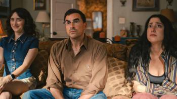 Big Mistakes: Nicky, Morgan and Natalie sit on a sofa in a living room, looking up at something off-camera; their facial expressions are bemused