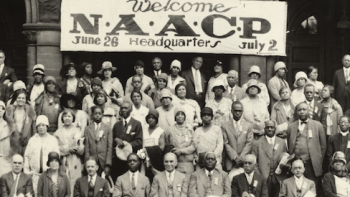 Black and Jewish America TV show screenshot 2: Black and Jewish individuals sit under a NAACP banner. 