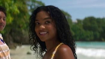 Black Cake TV show screenshot: Close up of a pretty teenage black girl smiling on the beach.