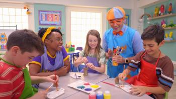 Blippi's Job Show TV show screenshot 2: Meekah and Blippi sit at a round table, where they teach art to two boys and one girl.