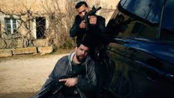 Blood Coast TV show screenshot #3: two men point guns from behind a car