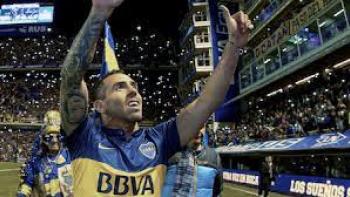 Boca Juniors Confidential TV: Soccer player Carlos Tevez has both hands up thanking the crowd after winning a game