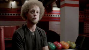 Born to Bowl TV show screenshot 1: Kyle Troup in black shirt with Afro-like red hair.