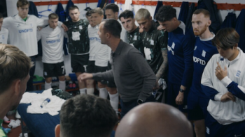 Built in Birmingham: Brady & The Blues TV show screenshot 2: Birmingham City players in locker room standing around talking coach.