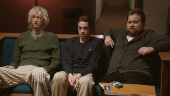 Bupkis TV show screenshot: Pete sits between two friends on a couch in a living room; all look disheveled and shell-shocked