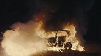 Burning Body TV show screenshot 2: A car engulfed in flames in the dark.