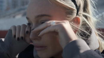 Call Her Alex TV show screenshot 3: Close up of Alex Cooper wiping tears from eyes.