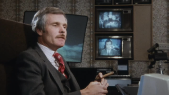  Call Me Ted TV show screenshot 2: Ted Turner sits holding a cigar in room with multiple t.v. sets on wall.