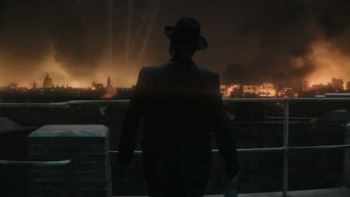 Churchill at War screenshot 2: Behind Churchill as he stands looking at a fiery London being blitzed. 