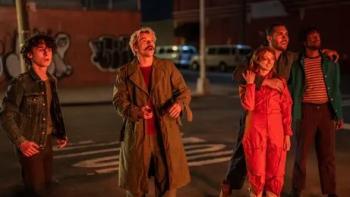 City on Fire TV show: onlookers watch something glowing, maybe a fire, from the sidewalk