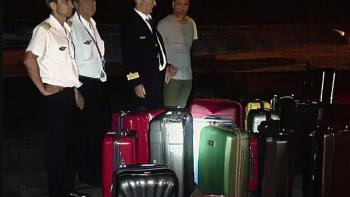 Cocaine Air: the pilots stand near 26 suitcases filled with drugs