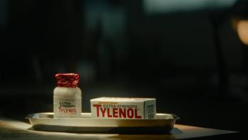 Cold Case: The Tylenol Murders TV show screenshot 1: Roy Lane sits at a desk with his fingers laced together. He wears a light blue button up shirt.