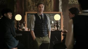Coven Academy TV show screenshot 2: Mr. Cole instructs students on magic flanked by two students in a classroom