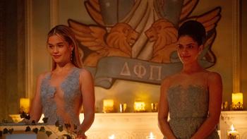 Cruel Intentions TV show screenshot 2: Caroline and Cece wear pale blue dresses while addressing sorority sisters while standing onstage
